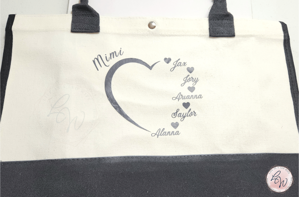 Vinyl design of a heart saying "Mimi" on the top and names of 5 grandchildren forming the right side of the heart on a tote bag to use as a Mother's Day gift.