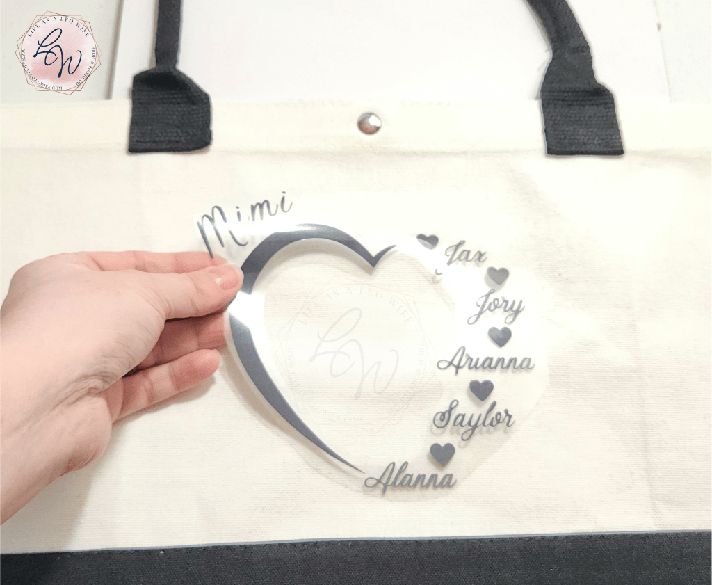 Centering the iron-on Mother's Day grandmother gift design on the canvas bag.