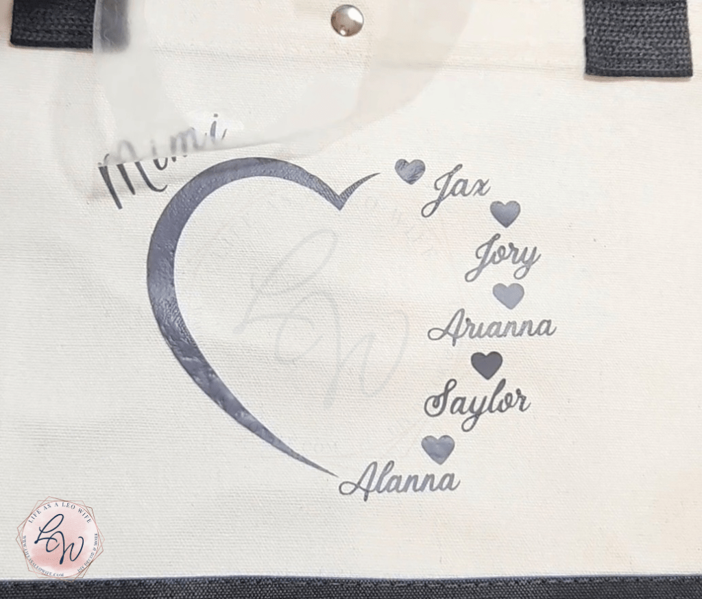 Removing the plastic cover from the Mother's Day vinyl design transferred onto the tote bag.