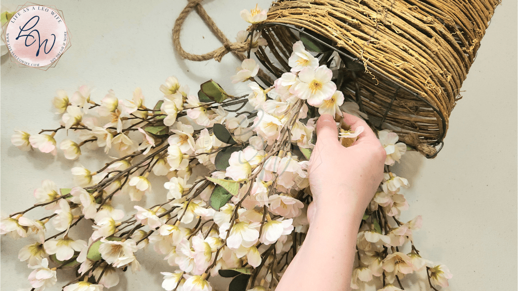 Placing a cherry blossom stem into the door basket.