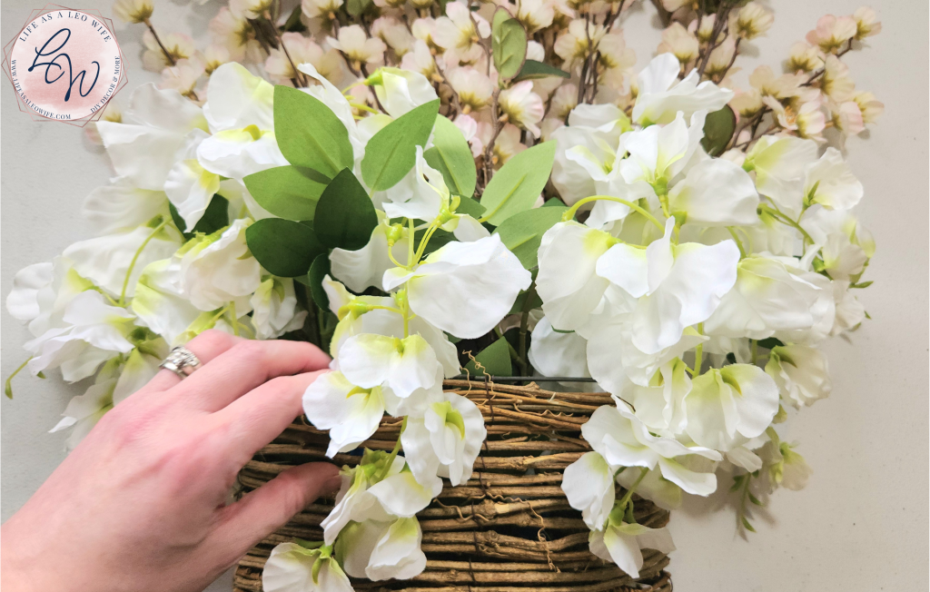Adjusting the second wisteria bush inside the door basket.